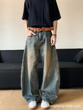 Men modelling retro blue distressed wide-leg jeans with machete detailing and a slimming fit.