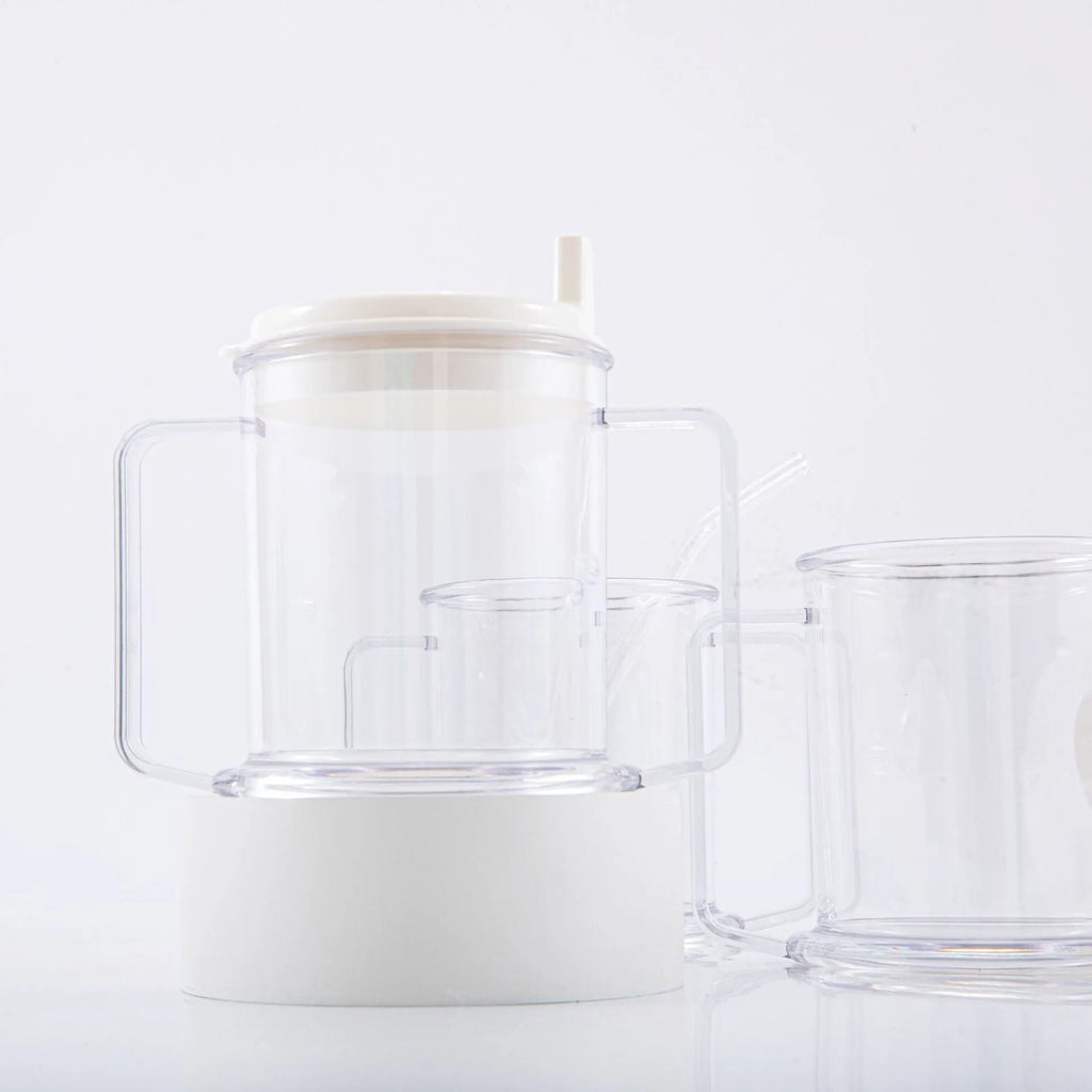 Transparent plastic spill-proof drinking cup on a table.
