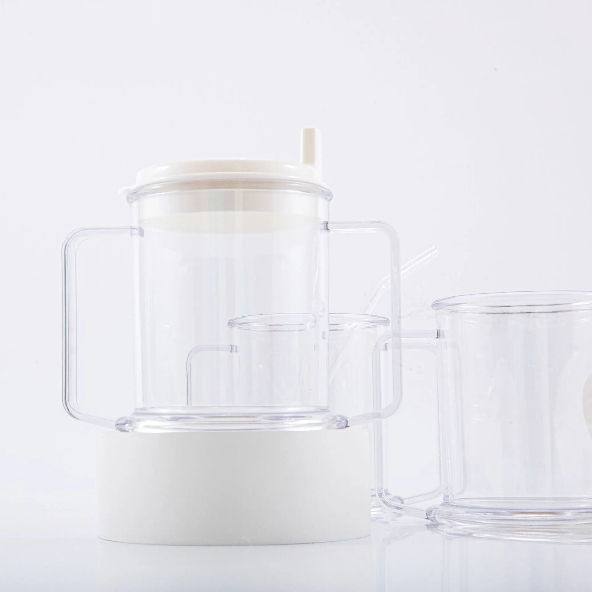 Transparent plastic spill-proof drinking cup on a table.