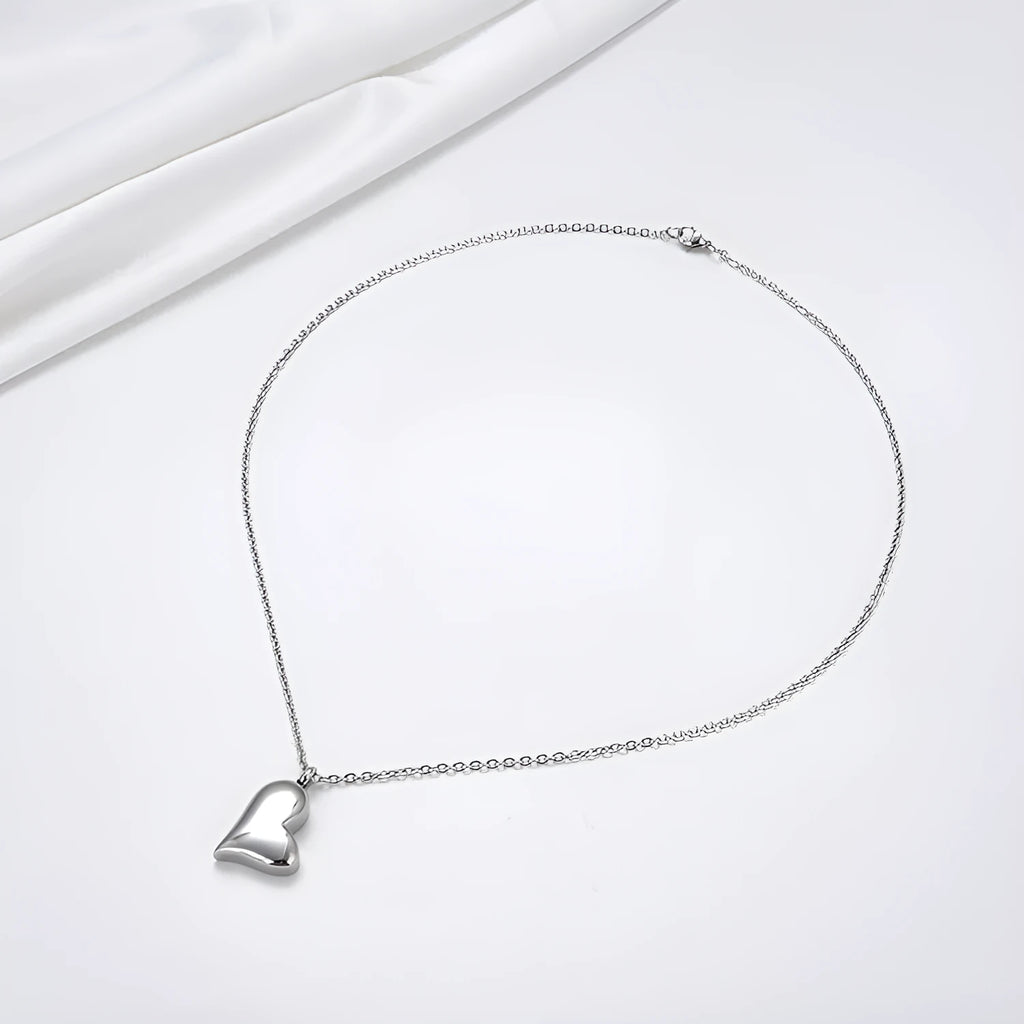 Silver curved peach heart pendant on a stainless steel necklace chain