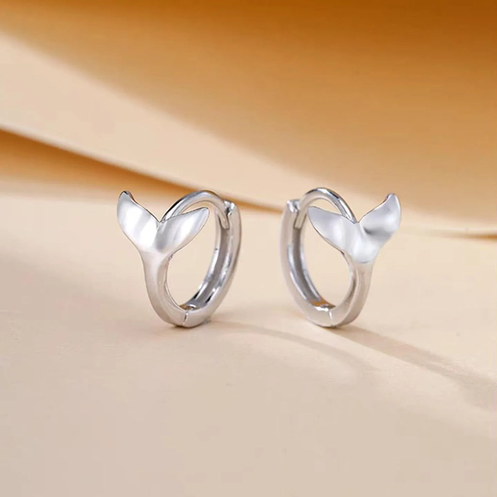 Women's fishtail design earrings with gold electroplating on copper, showing white gold and yellow gold colour options