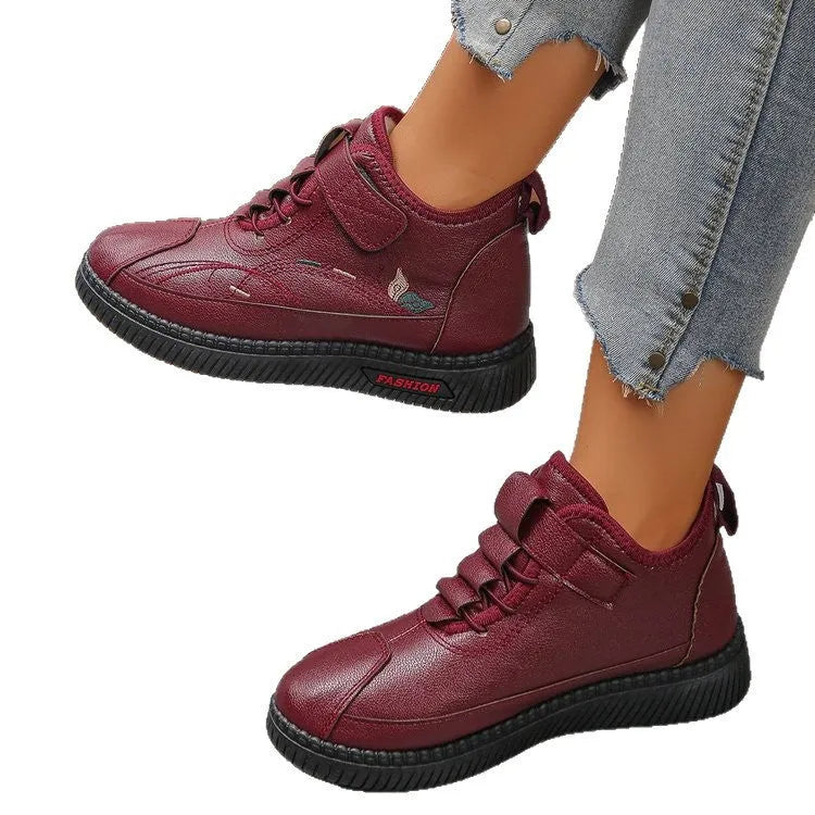 Women's black velvet slippers with a low-cut socks design and a light-coloured rubber sole.
