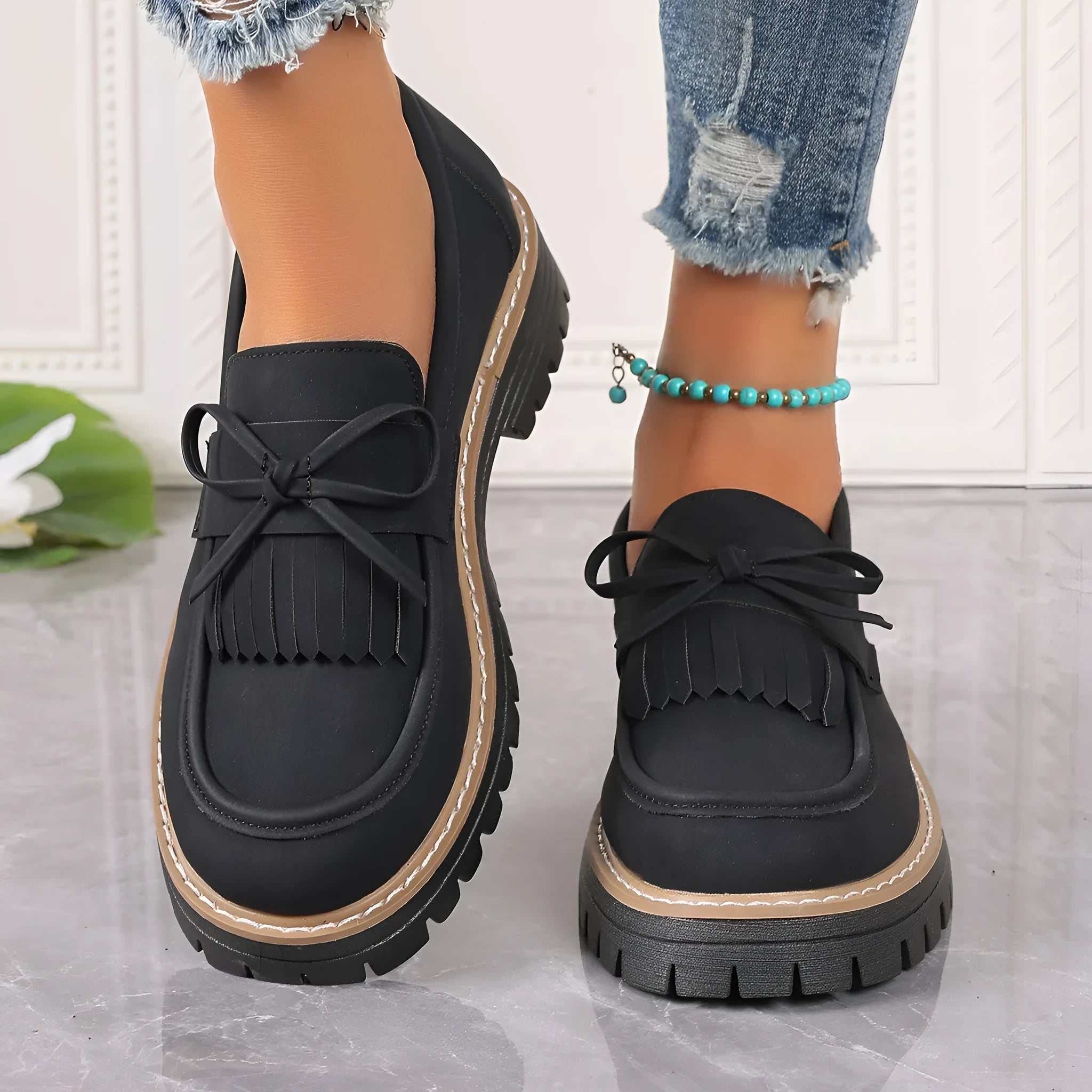 Plus size black loafers for women with a tassel bowknot and chunky low heel.