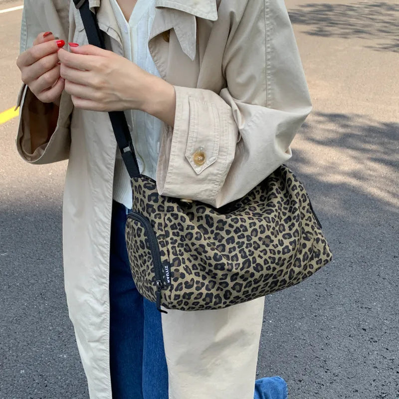 Large leopard print cross-body messenger bag with sports style shoulder strap