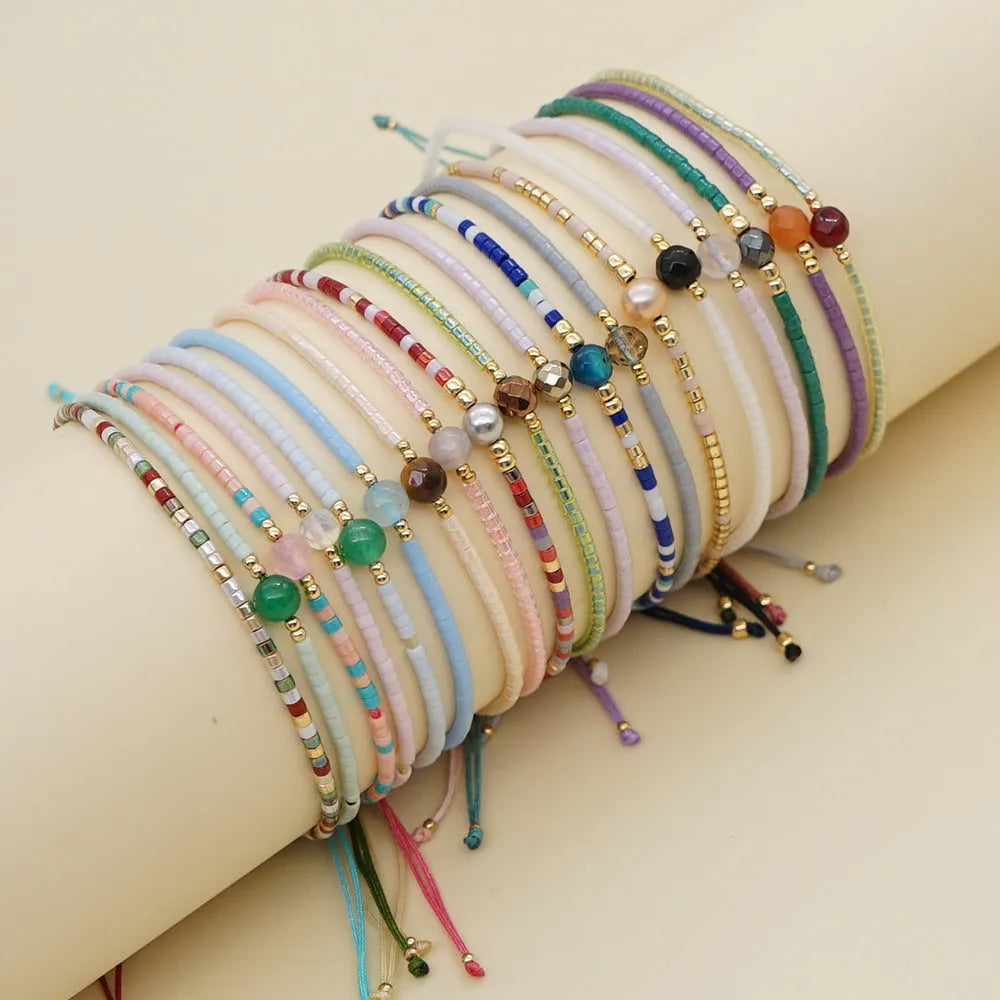 Handmade women's Bohemian bracelet with colourful glass beads and a central lucky stone bead.