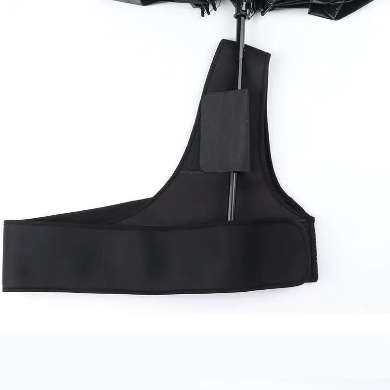 Black portable umbrella holder with shoulder strap for hands-free use with a manual umbrella.