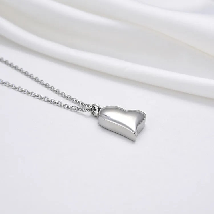 Silver curved peach heart pendant on a stainless steel necklace chain