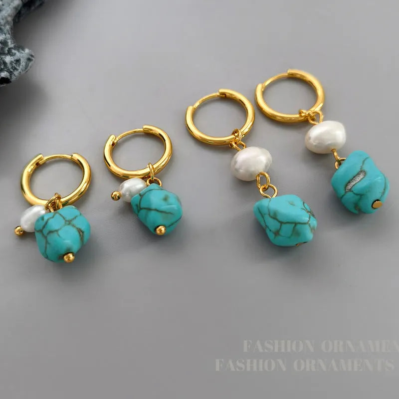 A pair of geometric copper earrings with irregular turquoise stones and cultured pearls