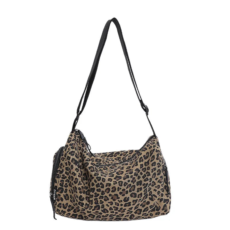 Large leopard print cross-body messenger bag with sports style shoulder strap