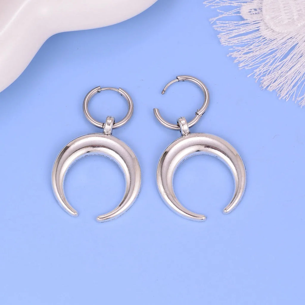 Silver gothic moon hoop earrings with geometric punk design and ear clip fastening