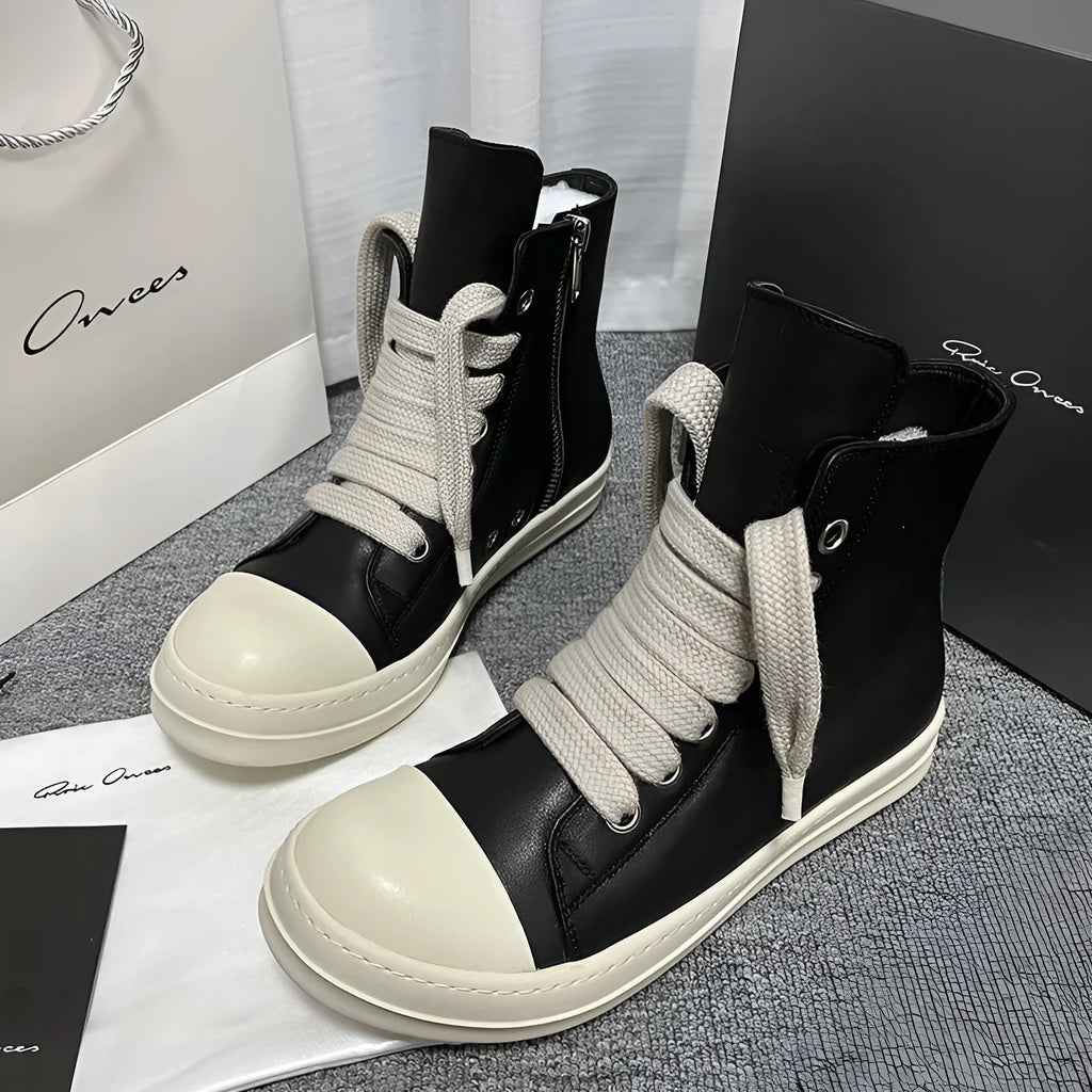 Men's and women's black high-top leather sneakers with a side zipper and round toe on a rubber sole.