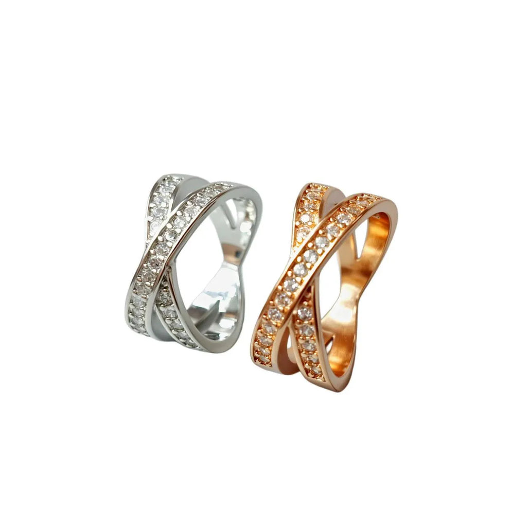 Silver and rose gold cross ring with micro-inlaid zircon stones on a simple geometric band.