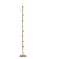 A tall, modern minimalist floor lamp with a wrought iron and glass body standing on a circular marble base.