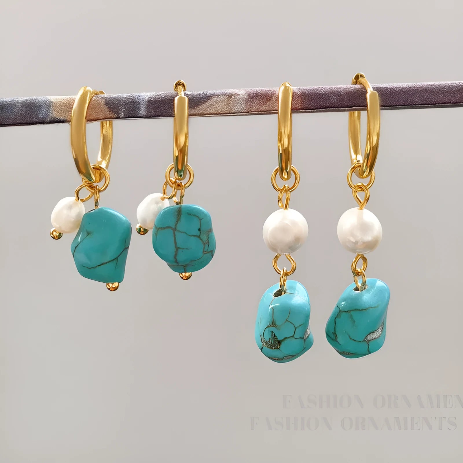 A pair of geometric copper earrings with irregular turquoise stones and cultured pearls