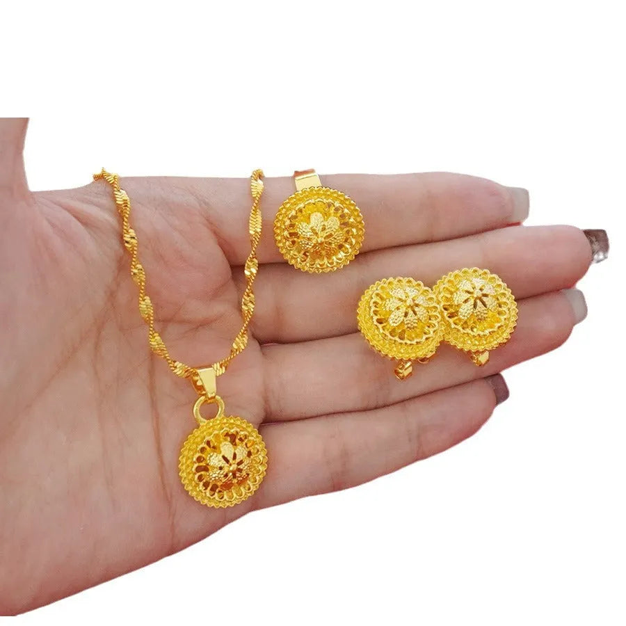 Gold plated three-piece jewellery set with floral pendant, matching earrings and ring