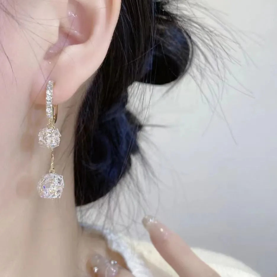 Silver tassel ball earrings with confession balloon pendant and rhinestone details on ear clips
