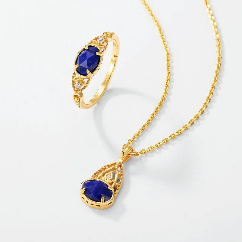 Close-up of a silver elliptical ring with a deep blue lapis lazuli stone set in a geometric band.