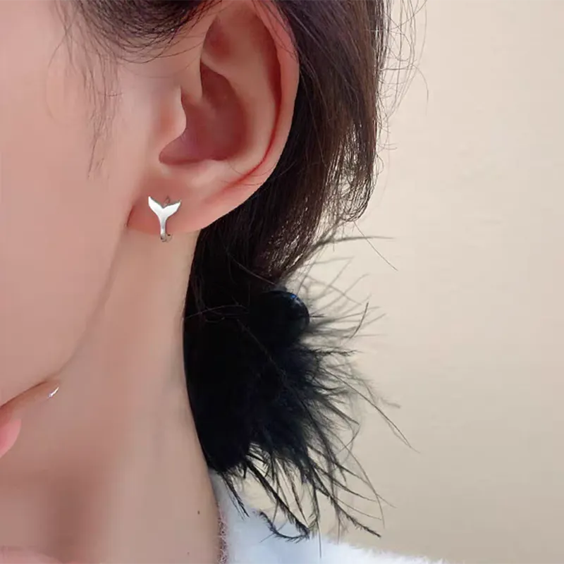 Women's fishtail design earrings with gold electroplating on copper, showing white gold and yellow gold colour options