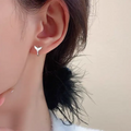 Women's fishtail design earrings with gold electroplating on copper, showing white gold and yellow gold colour options