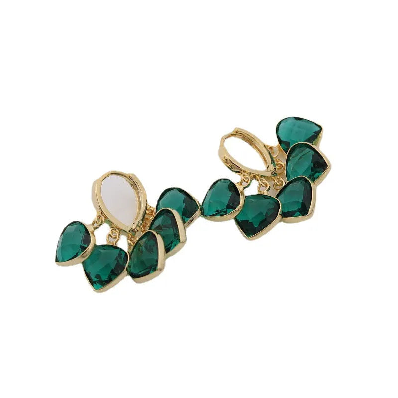 Pair of green heart-shaped glass pendant ear clip earrings with alloy inlay detail.