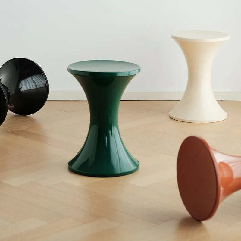 Hourglass-shaped plastic shoe changing stool in green, shown as a step aid.