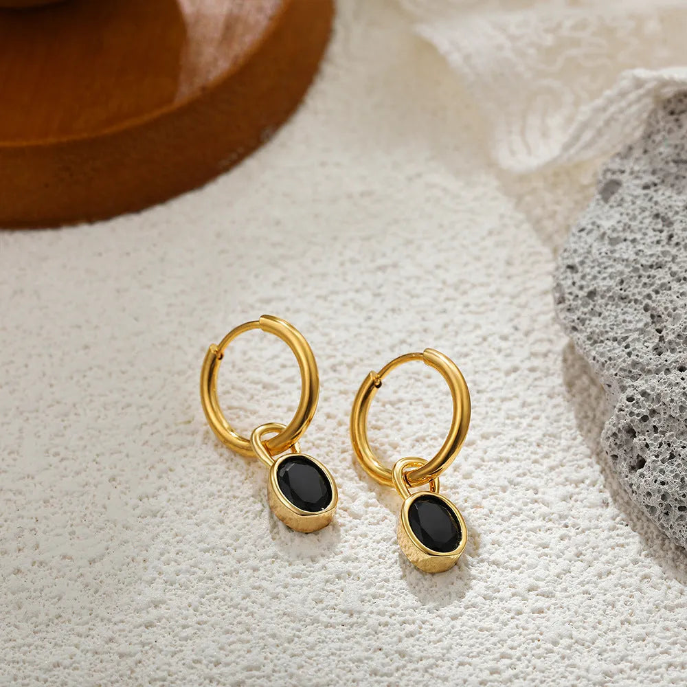 Close-up of women's retro oval zircon earrings in copper setting, showing ellipse design.