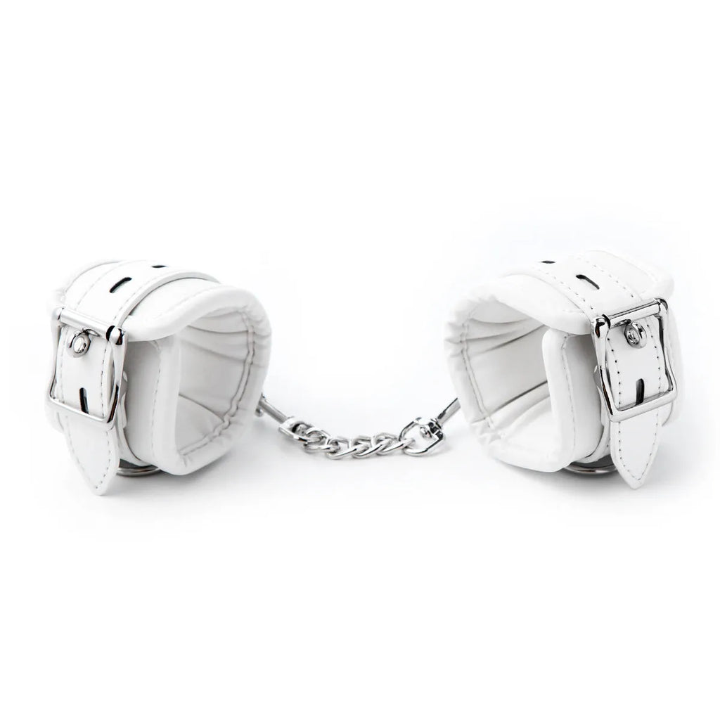 White PU sponge adult restraint set showing handcuffs, foot cuffs, and a neck cuff.