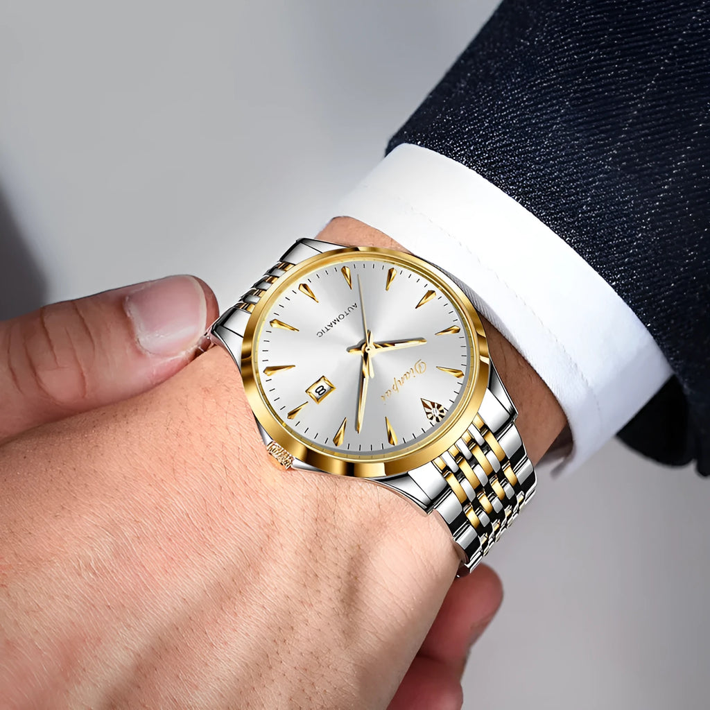 Men's simple dial automatic watch with stainless steel bracelet on a wrist.