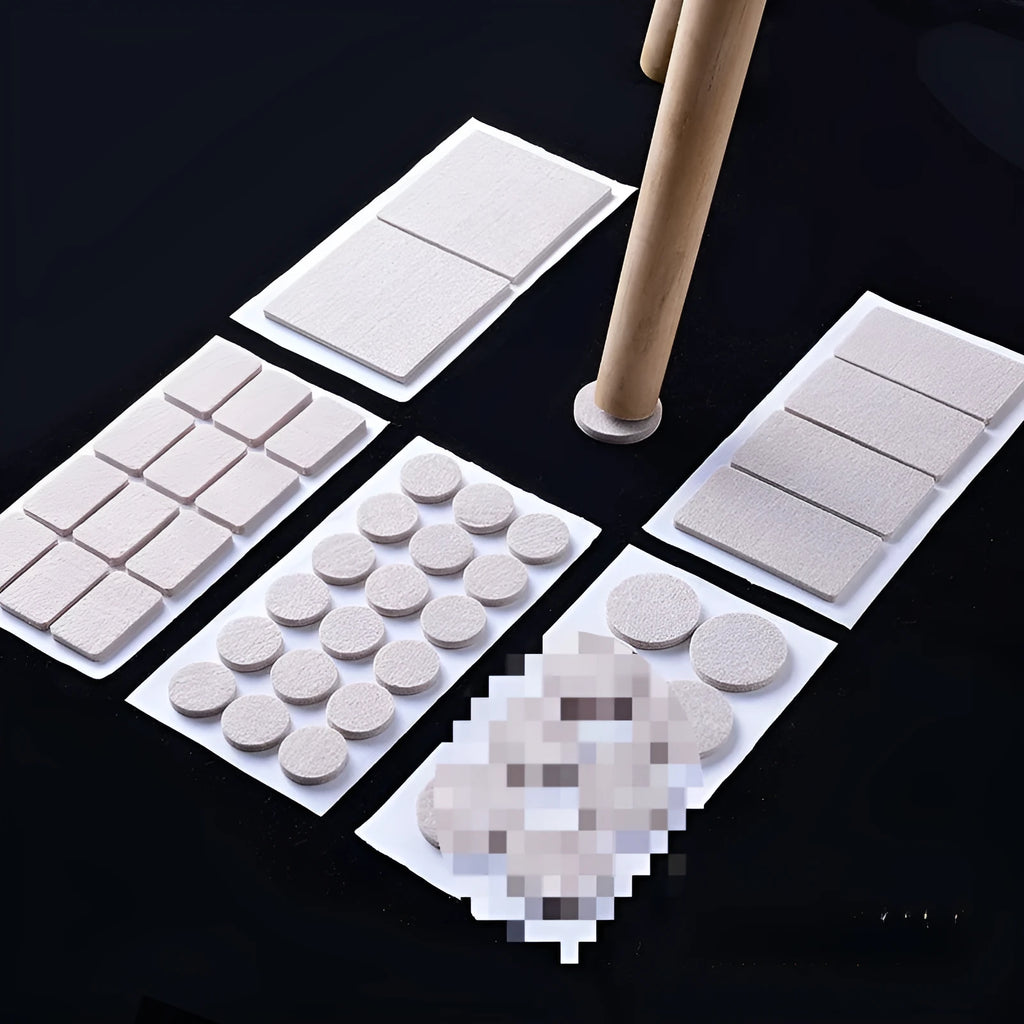 Assortment of beige plastic furniture leg protection pads in round and square sizes on wooden floor