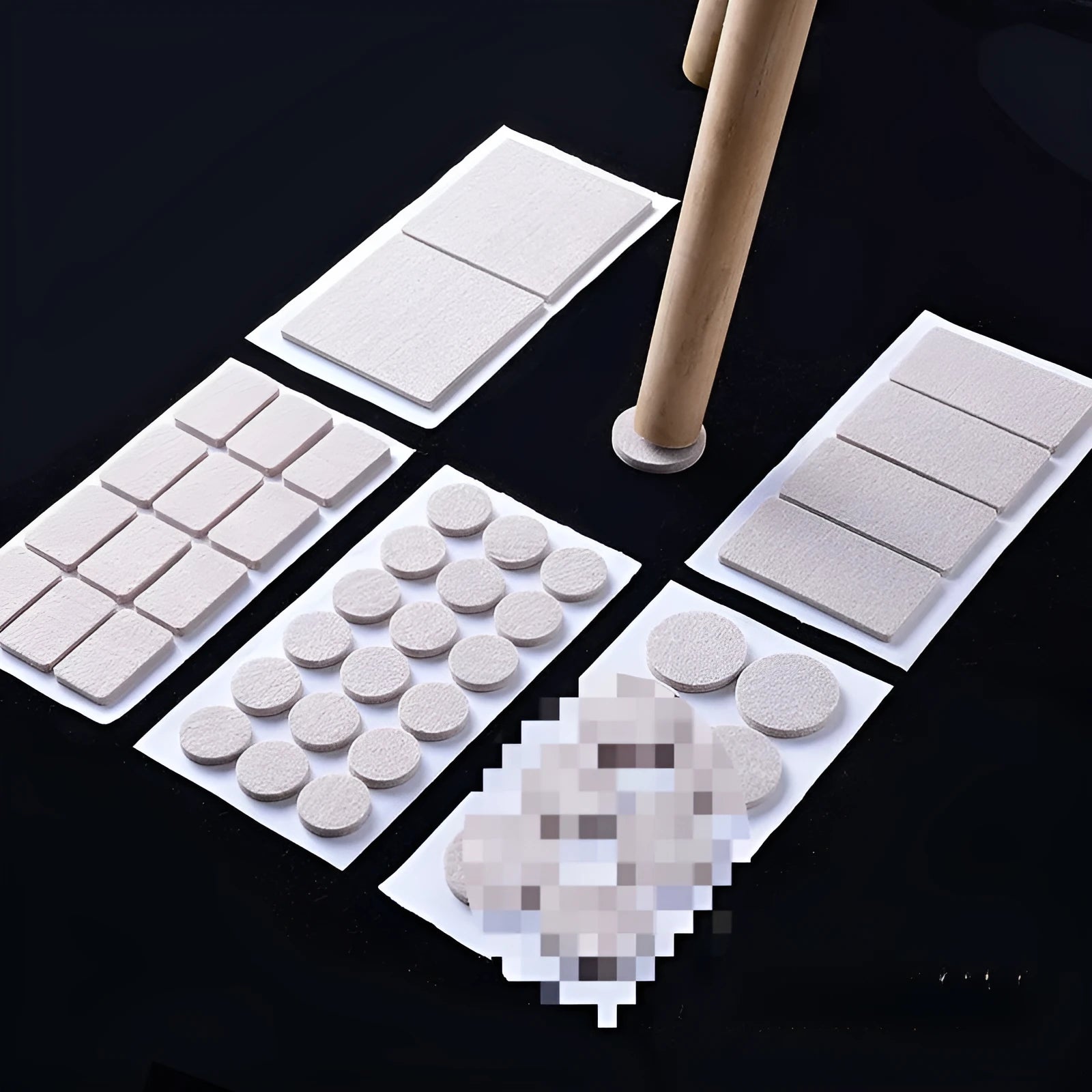 Assortment of beige plastic furniture leg protection pads in round and square sizes on wooden floor