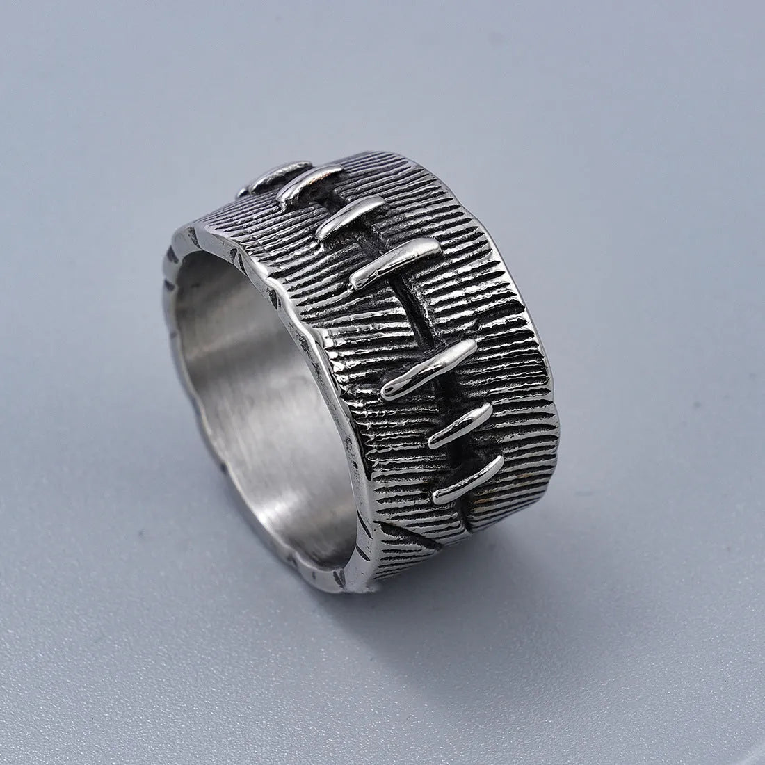 Titanium steel geometric double ring with U-shape, stitched pattern, and retro dark colour