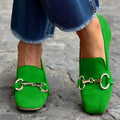 Green suede flat loafers with round toe and metal fastener on rubber sole