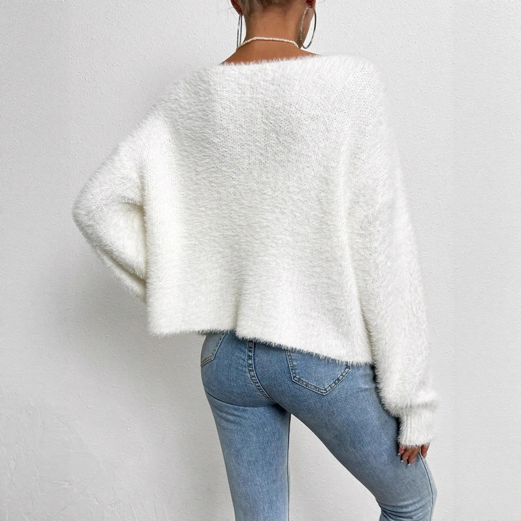 White women's V-neck cardigan sweater with medium thickness polyester construction