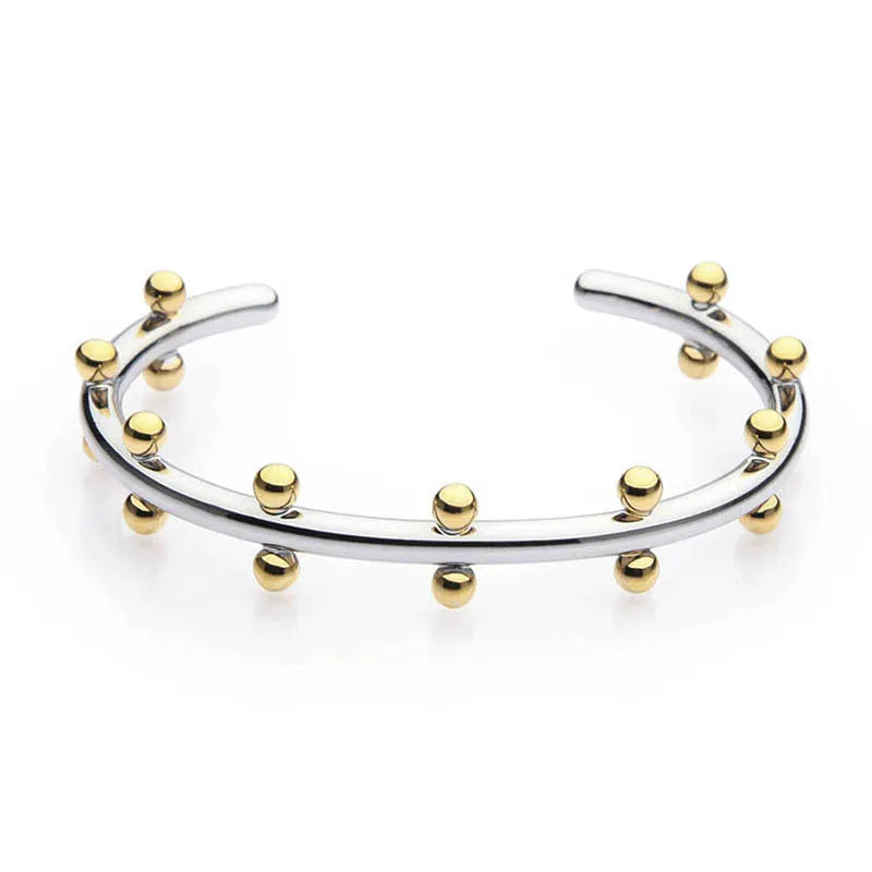Stainless steel bracelet with textured C-shaped bead links and raised rivet details.