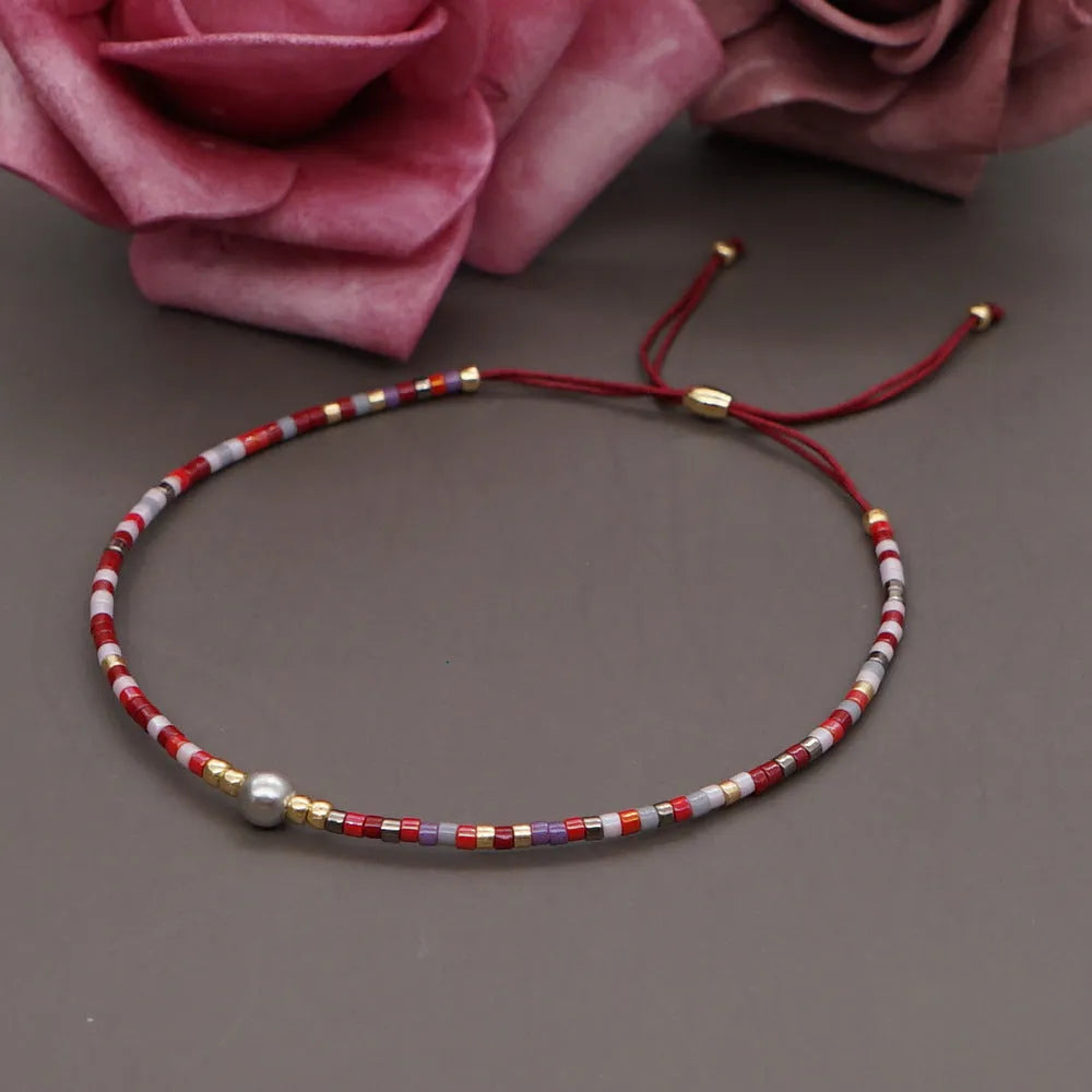 Handmade women's Bohemian bracelet with colourful glass beads and a central lucky stone bead.