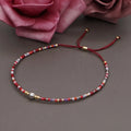 Handmade women's Bohemian bracelet with colourful glass beads and a central lucky stone bead.