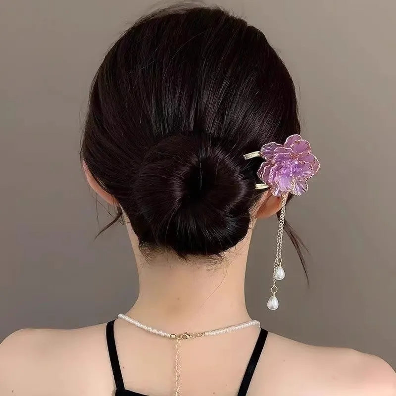 Close-up of a purple U-shaped alloy hairpin with a peony flower and tassel decoration.