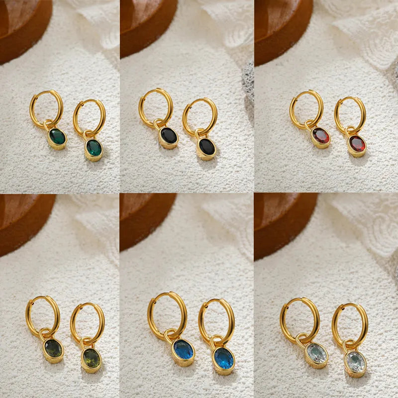 Close-up of women's retro oval zircon earrings in copper setting, showing ellipse design.
