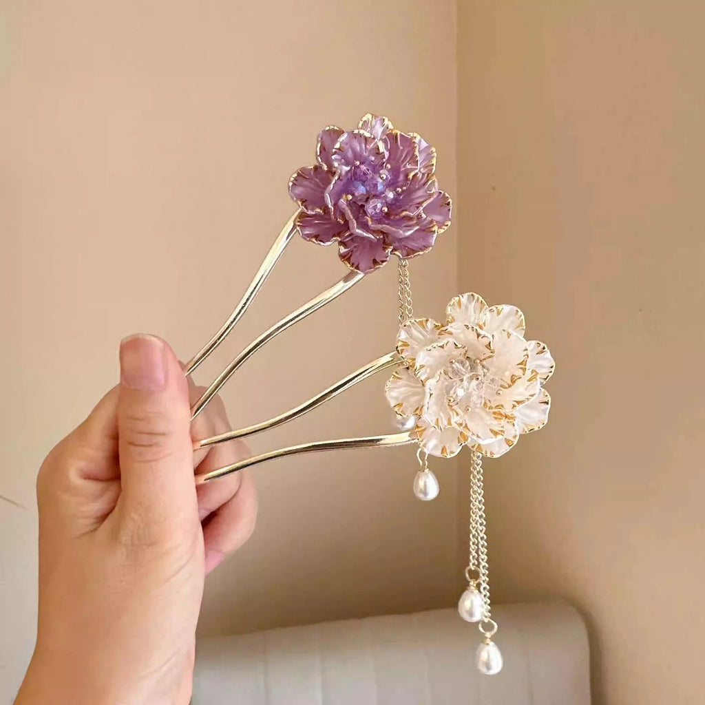 Close-up of a purple U-shaped alloy hairpin with a peony flower and tassel decoration.