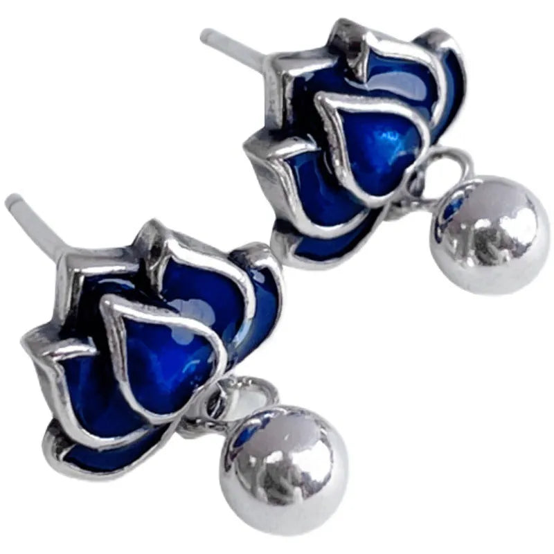 Blue alloy lotus flower stud earrings with a dangling seedpod tassel on silver posts.
