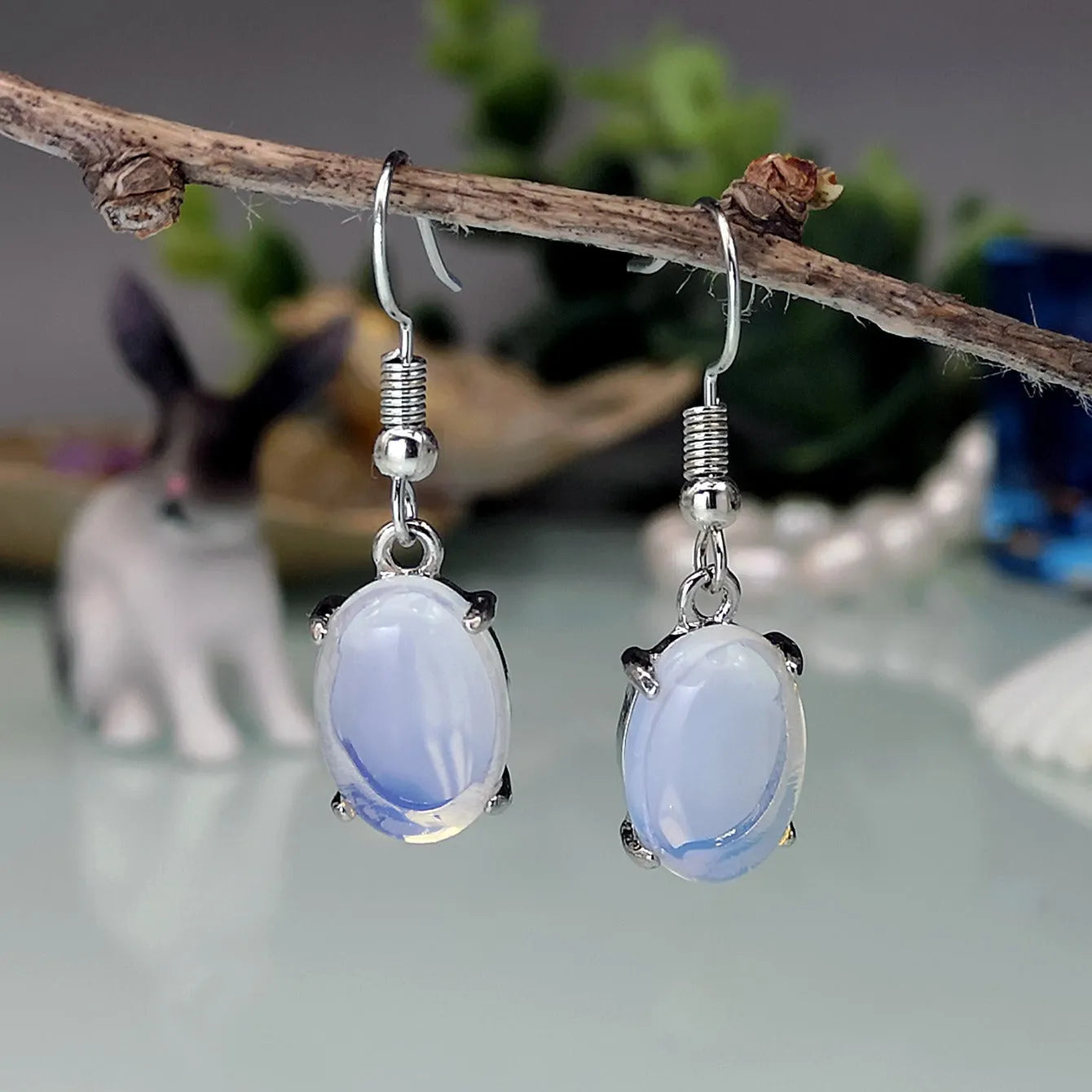 Moonlight opal drop earrings with retro cross design and ellipse detailing