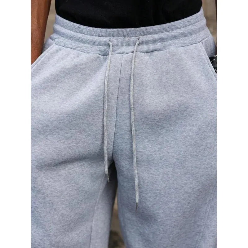 Men's straight-leg high-waist trousers in a grey colour, showcasing the cropped length and casual style.