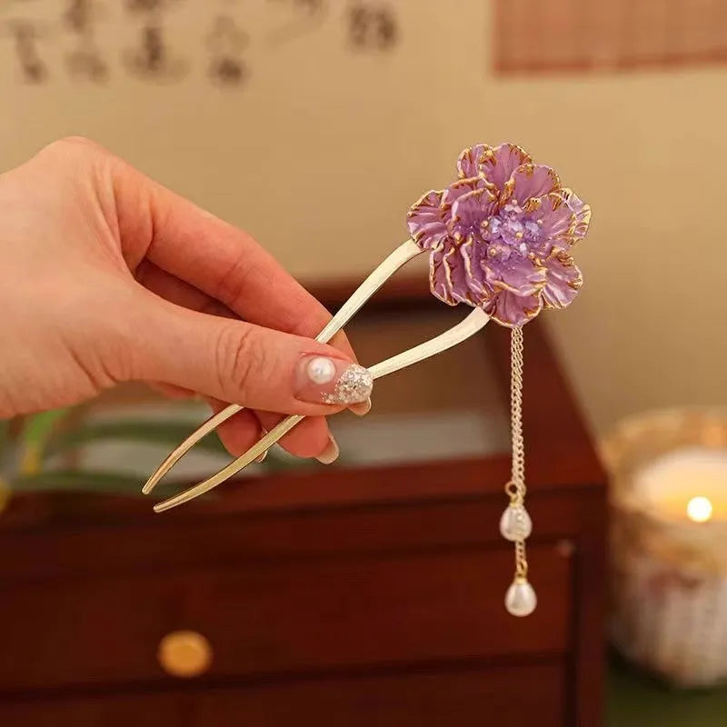 Close-up of a purple U-shaped alloy hairpin with a peony flower and tassel decoration.
