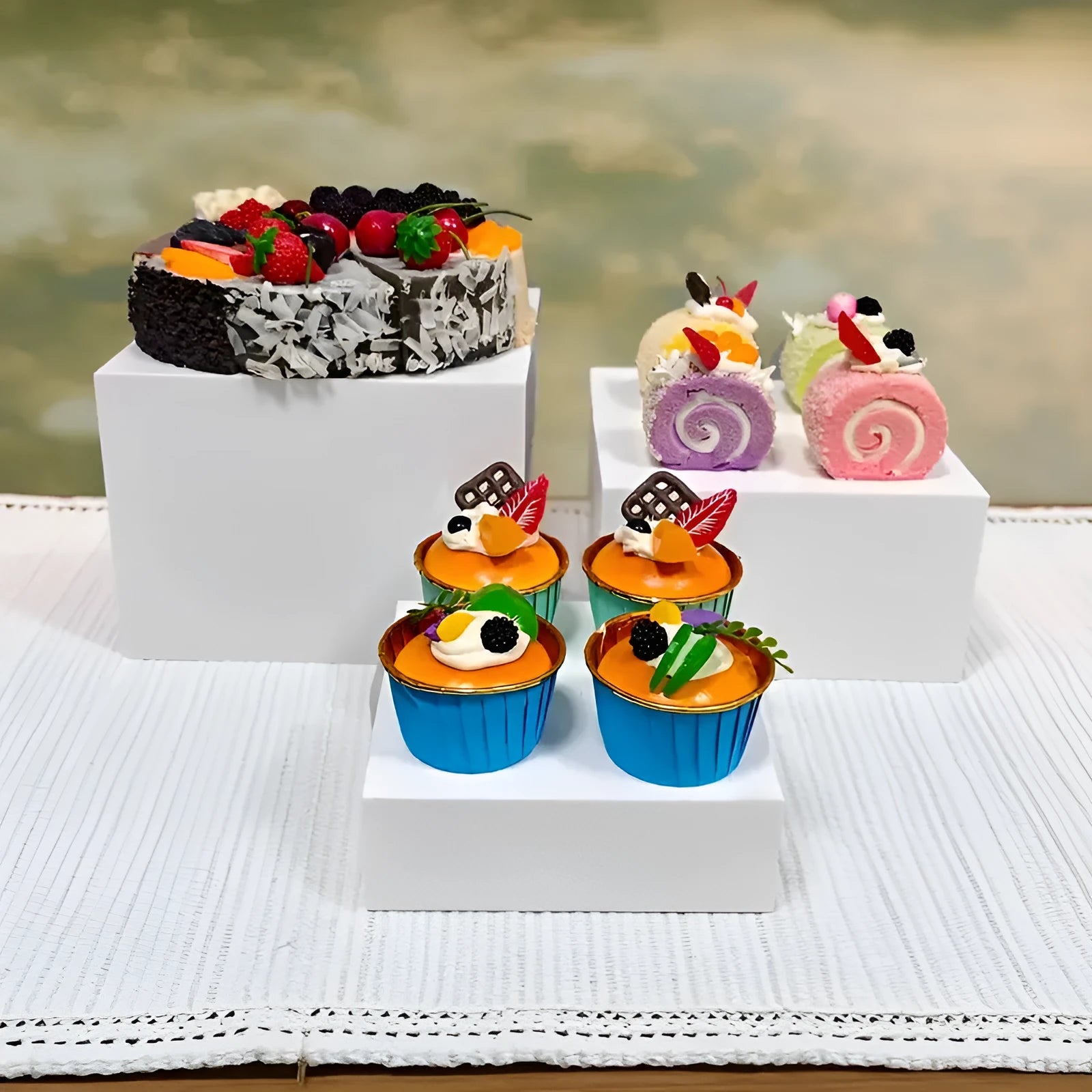 White plastic dessert display stand with six stacking cubes for tiered cake and dessert presentation