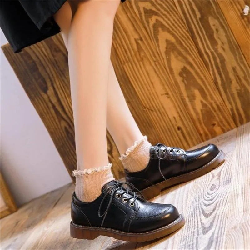 Women's black retro preppy Mary Jane shoes with front lace-up and low square heel on a white background