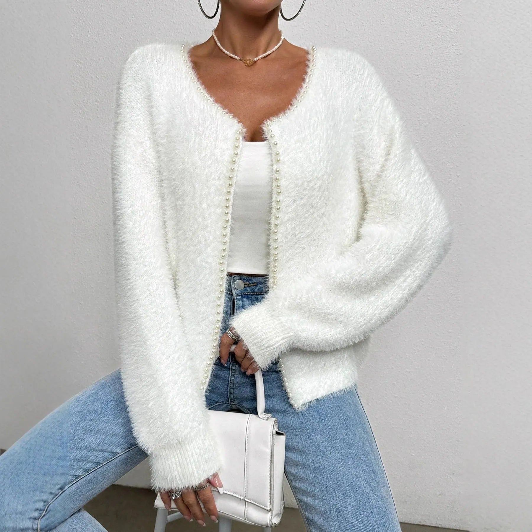 White women's V-neck cardigan sweater with medium thickness polyester construction