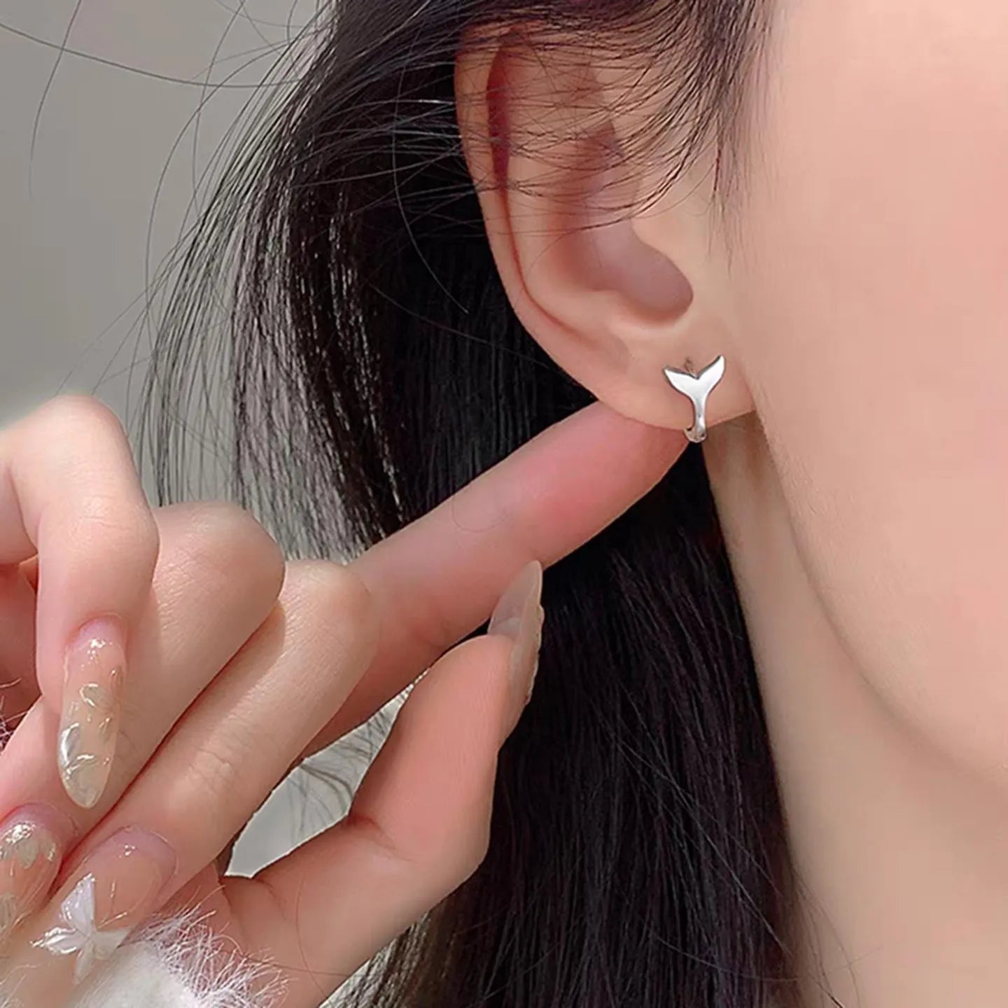 Women's fishtail design earrings with gold electroplating on copper, showing white gold and yellow gold colour options