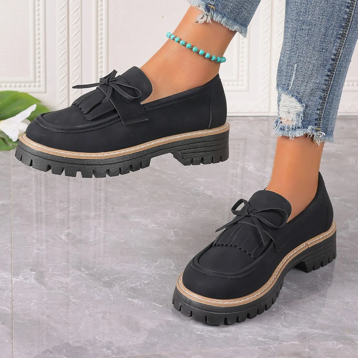 Plus size black loafers for women with a tassel bowknot and chunky low heel.