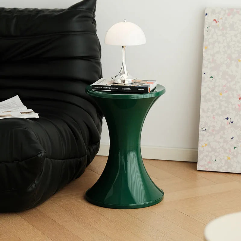 Hourglass-shaped plastic shoe changing stool in green, shown as a step aid.