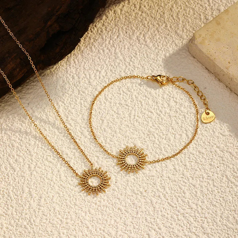 Sunflower pendant necklace and bracelet set in gold-plated stainless steel with geometric chain links